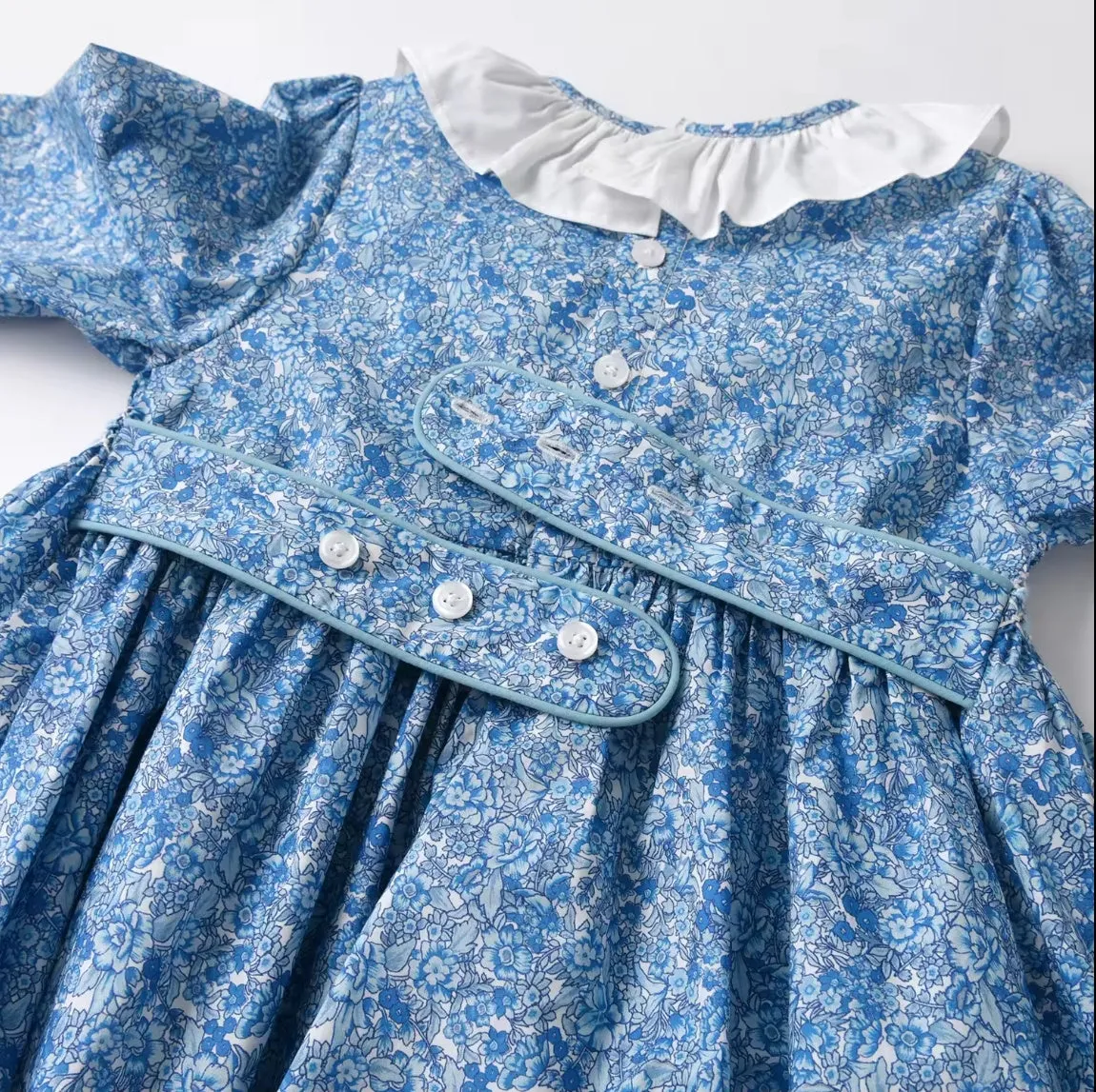 Smocked Girl's blue floral long sleeved dress